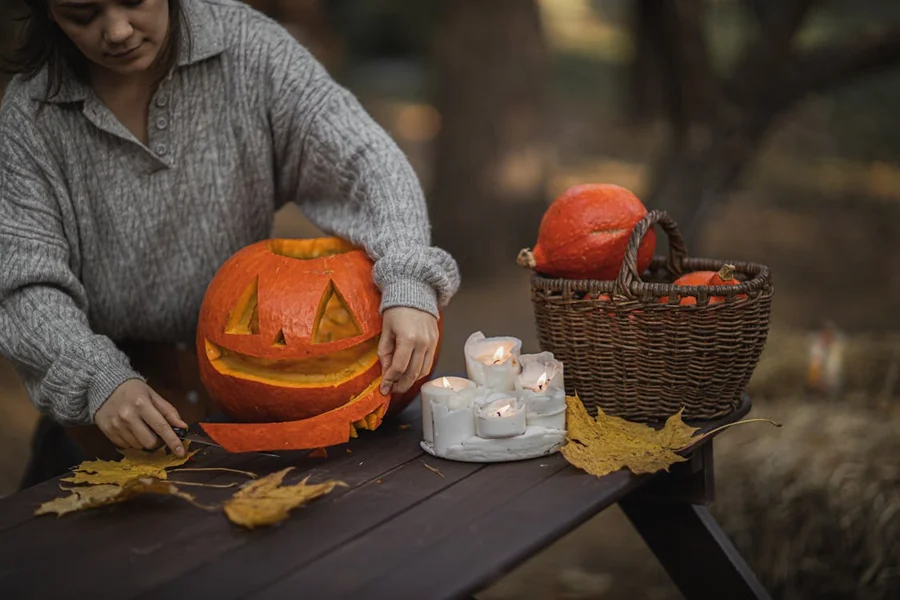 Woman carving Halloween pumpkin